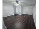 Bright living room featuring updated dark wood floors, white walls, and fan at 1263 Barefoot Trl, Greenwood, IN 46142