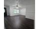 Bright living room featuring updated dark wood floors, white walls, and window with blinds at 1263 Barefoot Trl, Greenwood, IN 46142
