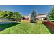 Lush backyard featuring a well-maintained lawn, a wooden fence, and mature trees, perfect for outdoor activities and relaxation at 12878 Ari Ln, Fishers, IN 46037
