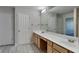 Bright bathroom featuring double sinks, spacious vanity, and a large mirror, offering style and functionality at 12878 Ari Ln, Fishers, IN 46037
