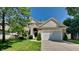 Charming two-story home with a well-manicured lawn and attached two-car garage, complemented by mature trees at 12878 Ari Ln, Fishers, IN 46037