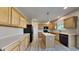 Well-lit kitchen featuring ample cabinetry, sleek countertops, modern appliances and wood-look floors at 12878 Ari Ln, Fishers, IN 46037