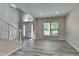 Open living room with wood-look flooring, a high ceiling, and an arched window above the front door at 12878 Ari Ln, Fishers, IN 46037