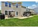 This outdoor patio features an umbrella-covered table, a grill, and a gazebo-covered hot tub, ideal for relaxation at 12993 E 131St St, Fishers, IN 46037