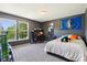 This bedroom offers a cozy retreat with carpet floors, a queen-size bed, and a window overlooking the backyard at 12993 E 131St St, Fishers, IN 46037