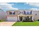 Charming two-story home with a well-manicured lawn, two car garage and a welcoming front porch at 12993 E 131St St, Fishers, IN 46037
