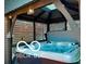 An inviting gazebo featuring a hot tub provides a serene escape with ambient lighting at 12993 E 131St St, Fishers, IN 46037