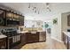 Modern kitchen featuring brown cabinets, stainless steel appliances, and a stylish countertop at 12993 E 131St St, Fishers, IN 46037