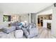 Cozy living room with modern gray furniture, open layout, and seamless transition into the adjacent kitchen and dining area at 12993 E 131St St, Fishers, IN 46037