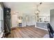 Spacious open-concept living area with gray walls, stylish gray flooring, neutral furniture, and an open floor plan at 12993 E 131St St, Fishers, IN 46037