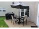 Cozy outdoor patio area with table, chairs, umbrella, and grill, perfect for relaxing and entertaining at 12993 E 131St St, Fishers, IN 46037