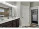 Bathroom featuring a double vanity, tile backsplash, and walk-in closet at 1334 Sunnybrook Ln, Greenwood, IN 46143
