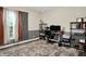 Comfortable home office space with a large patterned rug, a window for natural light and modern shelving units at 1334 Sunnybrook Ln, Greenwood, IN 46143