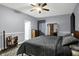 Relaxing bedroom with gray walls, ceiling fan, and decorative furniture at 1334 Sunnybrook Ln, Greenwood, IN 46143