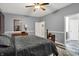 Bright bedroom with gray walls, featuring a ceiling fan and dark wood furniture at 1334 Sunnybrook Ln, Greenwood, IN 46143