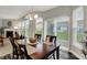 Bright dining room featuring a modern chandelier with backyard views and fireplace at 1334 Sunnybrook Ln, Greenwood, IN 46143