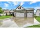 Attractive house with a three-car garage, a well-maintained lawn, and tasteful landscaping at 1334 Sunnybrook Ln, Greenwood, IN 46143