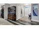 Inviting foyer featuring a decorative glass transom window, wood-look flooring, and an elegant china cabinet at 1334 Sunnybrook Ln, Greenwood, IN 46143