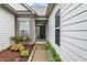 Inviting front entrance with a black front door, and well-kept landscaping with colorful plants at 1334 Sunnybrook Ln, Greenwood, IN 46143