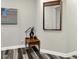 Tastefully decorated hallway nook with stylish mirror, modern lamp and wood flooring at 1334 Sunnybrook Ln, Greenwood, IN 46143