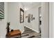 Inviting hallway with stylish wood floors, decorative mirror, and an array of framed art pieces at 1334 Sunnybrook Ln, Greenwood, IN 46143
