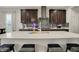 Kitchen island featuring a white countertop with barstool seating and dark stained cabinets at 1334 Sunnybrook Ln, Greenwood, IN 46143