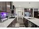 Modern kitchen with stainless steel appliances, spacious island, dark cabinets and stylish backsplash at 1334 Sunnybrook Ln, Greenwood, IN 46143