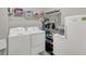 Functional laundry room with modern appliances and storage shelves at 1334 Sunnybrook Ln, Greenwood, IN 46143