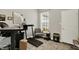 Home office with a large window, desk, treadmill and comfortable chair at 1334 Sunnybrook Ln, Greenwood, IN 46143