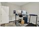 Functional home office featuring a modern desk, treadmill, and neutral decor at 1334 Sunnybrook Ln, Greenwood, IN 46143