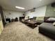 Finished basement with a large sofa, recliner, tv and carpeted floor at 144 S 7Th Ave, Beech Grove, IN 46107