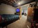 Basement bedroom with tv, storage, and view into another room at 144 S 7Th Ave, Beech Grove, IN 46107