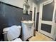Updated bathroom with gray accent tiles and white fixtures at 144 S 7Th Ave, Beech Grove, IN 46107