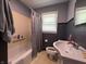 Bathroom featuring a shower and bath with a bright window at 144 S 7Th Ave, Beech Grove, IN 46107