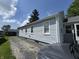 Charming house exterior with light blue siding, gray foundation, and concrete driveway at 144 S 7Th Ave, Beech Grove, IN 46107