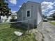 Home exterior showing fenced backyard and lengthy concrete driveway for parking at 144 S 7Th Ave, Beech Grove, IN 46107