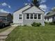 Charming home featuring well-maintained lawn, and a gray painted brick facade at 144 S 7Th Ave, Beech Grove, IN 46107