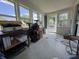 The enclosed porch offers natural light from multiple windows at 144 S 7Th Ave, Beech Grove, IN 46107