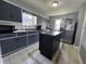 Functional kitchen featuring an island with stainless steel appliances at 144 S 7Th Ave, Beech Grove, IN 46107