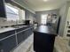 Well-lit kitchen with a center island, stainless steel appliances, and ample countertop space at 144 S 7Th Ave, Beech Grove, IN 46107