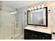 Bright bathroom featuring a glass enclosed shower, black vanity with white countertop, and an illuminated mirror at 16857 Palmetto Way, Noblesville, IN 46062