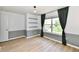 Bright bedroom featuring two-tone walls, a large window with curtains, and hardwood flooring at 16857 Palmetto Way, Noblesville, IN 46062
