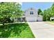 Inviting two-story home with a well-manicured lawn, charming landscaping, and a three-car garage at 16857 Palmetto Way, Noblesville, IN 46062