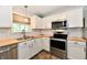 Well-lit kitchen with stainless steel appliances, white cabinets and stylish subway tile backsplash at 16857 Palmetto Way, Noblesville, IN 46062