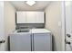 Convenient laundry room with washer, dryer, and overhead storage cabinets at 16857 Palmetto Way, Noblesville, IN 46062