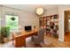 Home office with a wooden desk, ample lighting, and a window offering natural light and greenery views at 16857 Palmetto Way, Noblesville, IN 46062