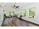 Inviting sunroom filled with natural light from large windows and hardwood floors throughout at 16857 Palmetto Way, Noblesville, IN 46062