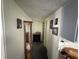 Hallway featuring pictures on the wall and a display cabinet with plenty of room for storage at 1801 E 16Th St, Muncie, IN 47302