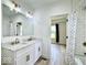 Bathroom with marble vanity and subway tiled shower with brushed gold fixtures at 1920 E Epler E Ave, Indianapolis, IN 46227