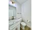 Half bath featuring marble countertop, white vanity and brushed gold fixtures at 1920 E Epler E Ave, Indianapolis, IN 46227